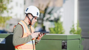 Man using phone to do intelligent voice dictation for field data capture - Audio Fastfill Voice Powered Field Data Capture Feature